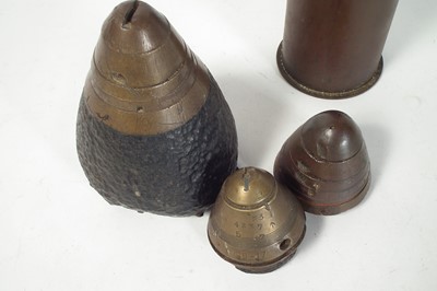 Lot 149 - Three WWI artillery fuses and a shell case