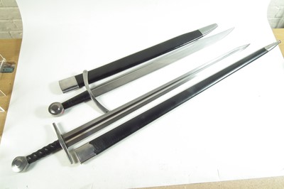 Lot 29 - Two modern replica swords and scabbards