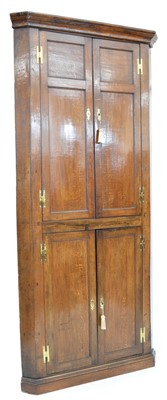 Lot 425 - George III oak double floor standing corner cupboard