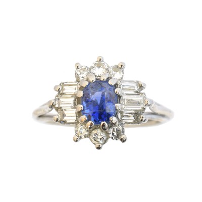 Lot 130 - A Sri Lankan sapphire and diamond cluster ring