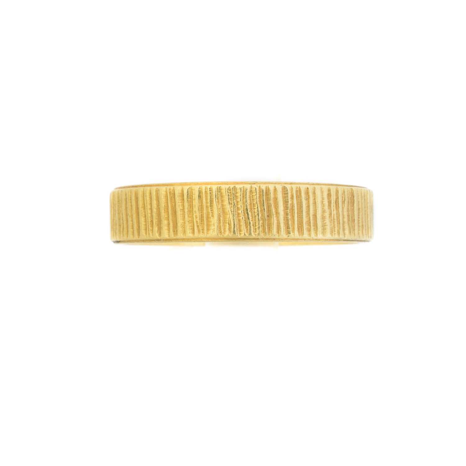 Lot 112 - An 18ct gold textured band ring