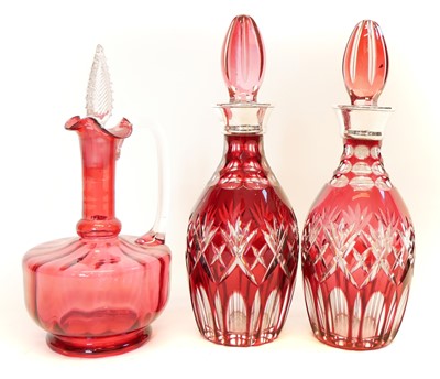 Lot 190 - A pair of flash ruby decanters and one other cranberry decanter.