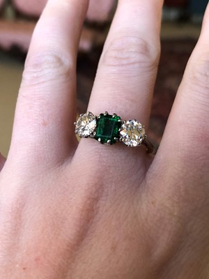 Lot 163 - An emerald and diamond three stone ring