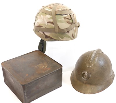 Lot 359 - Two helmets and a ration tin.