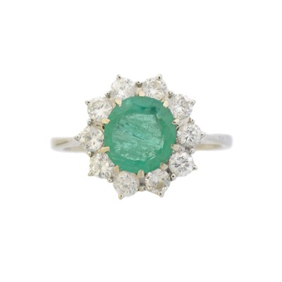 Lot 149 - An 18ct gold emerald and diamond cluster ring