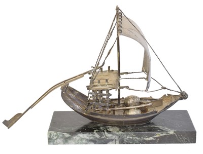 Lot 143 - A white metal model of a Chinese Junk Boat