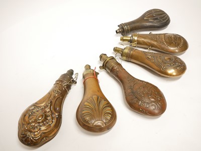 Lot 241 - Six embossed copper and brass powder flasks