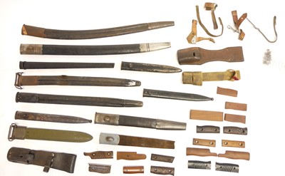Lot 356 - Eleven mixed bayonet scabbards also three frogs and bayonet grips