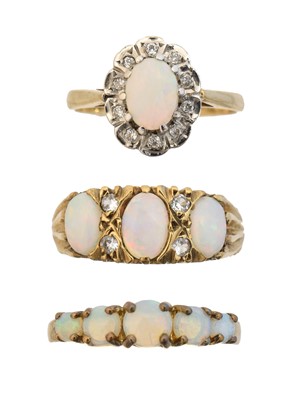 Lot 57 - Three 9ct gold opal dress rings