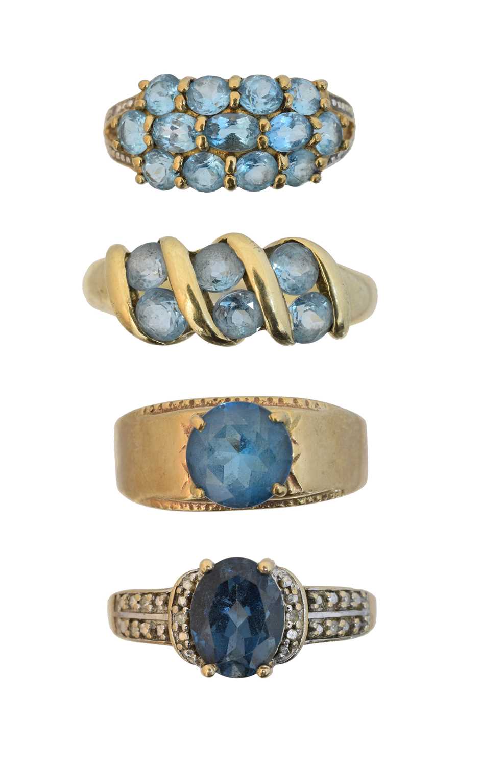 Lot 157 - Four 9ct gold blue topaz dress rings