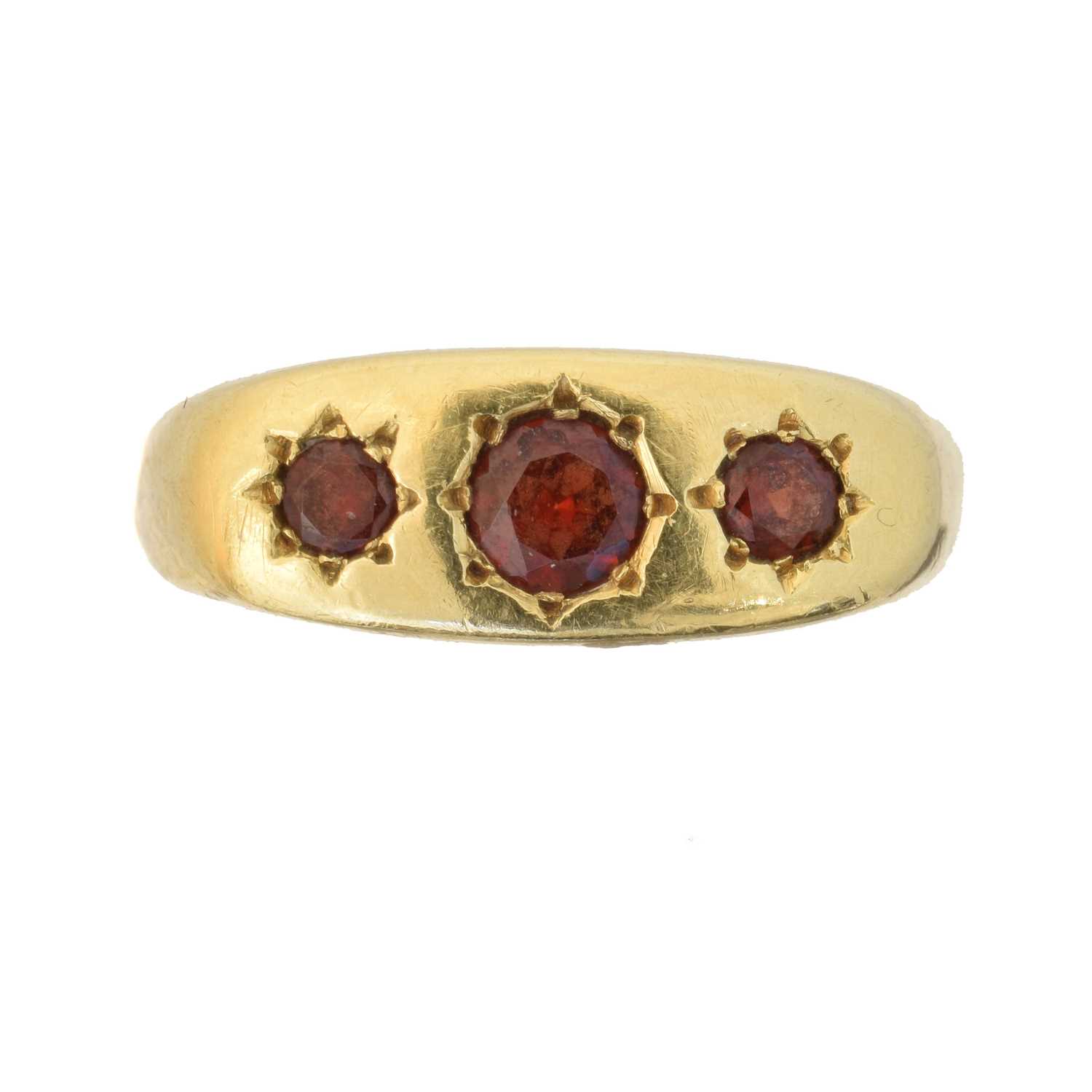 Lot 49 - An 18ct gold garnet three stone ring