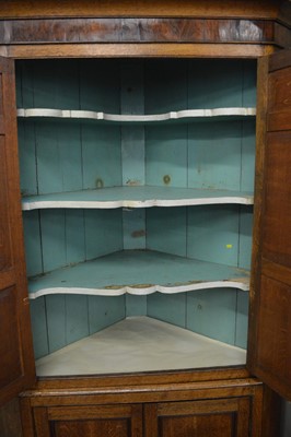 Lot 318 - George III oak floor standing corner cupboard