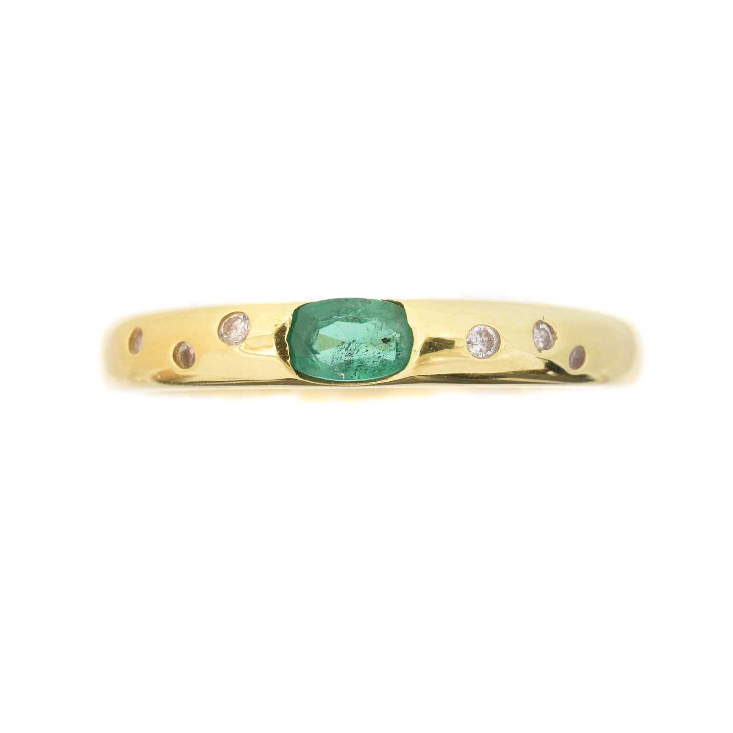 Lot 62 - An emerald and diamond band ring