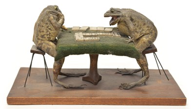 Lot 252 - Two stuffed toads sitting at a table playing domino's.