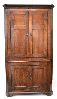 Lot 319 - George III oak floor standing corner cupboard
