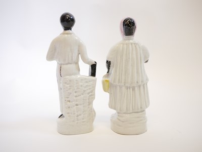 Lot 133 - Staffordshire figures of Uncle Tom and Aunt Chloe.