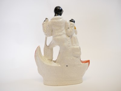 Lot 135 - Staffordshire Dudson pottery figure of Uncle Tom and Eva on a boat