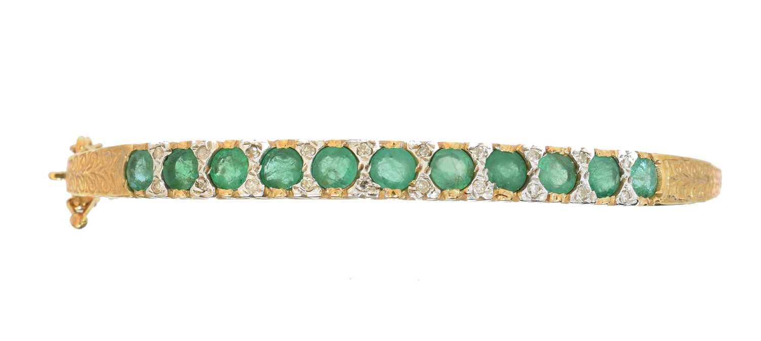 Lot A 9ct gold emerald and diamond hinged bangle
