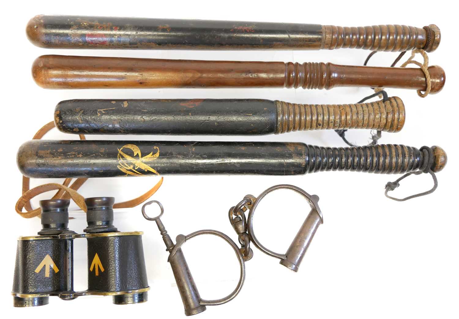 Lot 396 - Four truncheons, and hand cuffs
