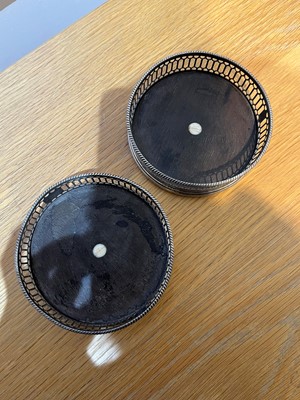 Lot 60 - A pair of George III silver wine coasters