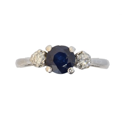 Lot 128 - An 18ct gold sapphire and diamond three stone ring