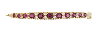 Lot 46 - A ruby and diamond hinged bangle