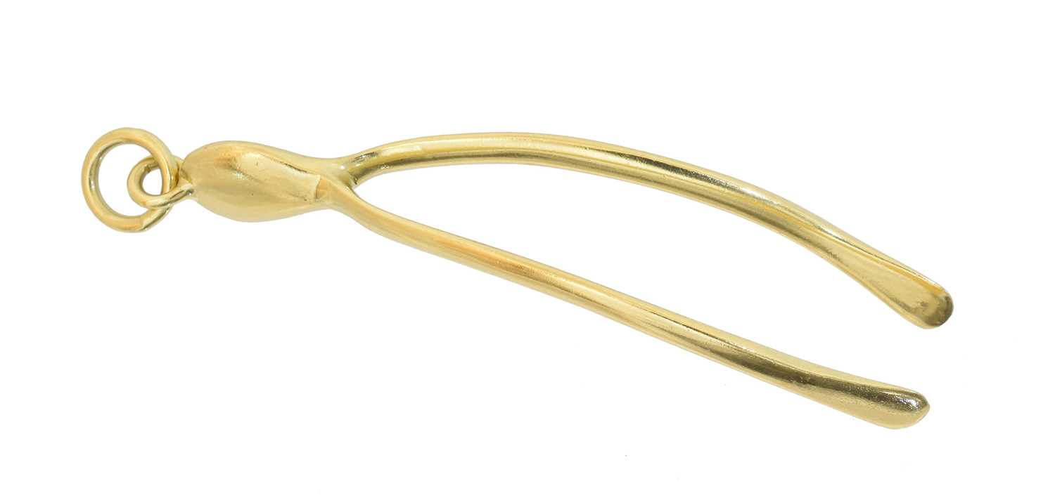 Lot 86 - An 18ct gold wishbone pendant