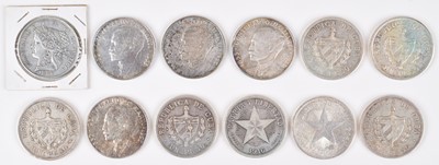 Lot 77 - Eleven Cuban 1 Peso silver coins and a Peru 5 Pesetas silver coin (12).
