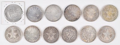 Lot 77 - Eleven Cuban 1 Peso silver coins and a Peru 5 Pesetas silver coin (12).