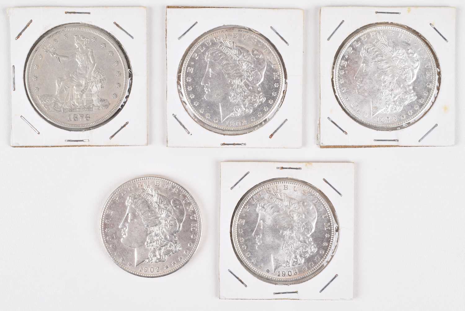Lot 80 - Four silver US Morgan dollars and a US 1878 silver trade dollar (5).