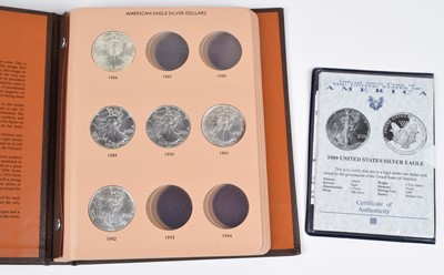 Lot 86 - Album containing six American Eagle Silver Dollars.