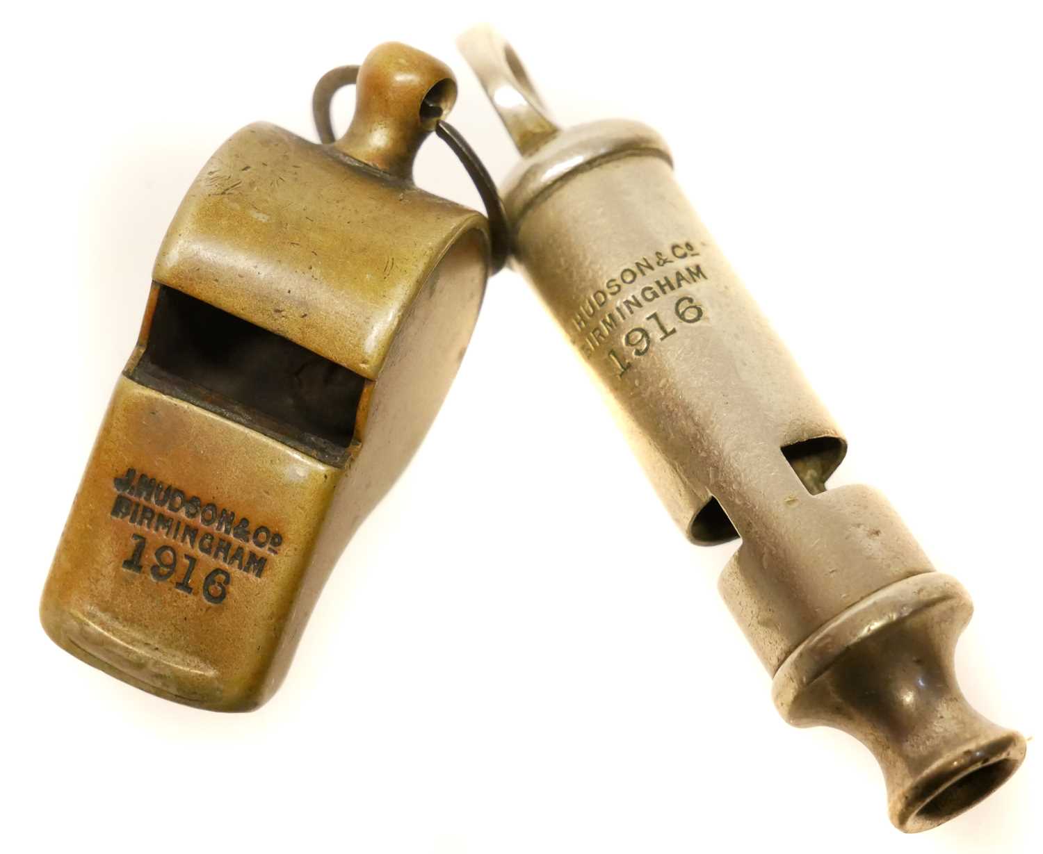 Lot 487 Two J. Hudson WWI era whistles,