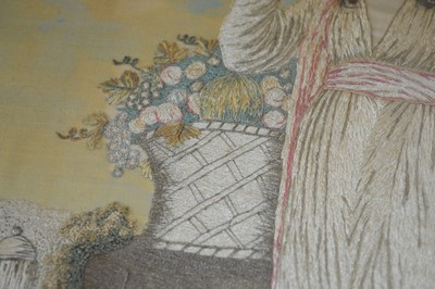 Lot 196 - A Georgian needlework silk picture depicting a standing female beside a column.