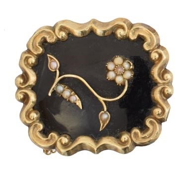 Lot 12 - A Victorian enamel and split pearl mourning brooch