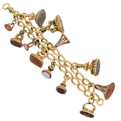 Lot 60 - An 18ct gold chain bracelet suspending gem-set seals and fobs