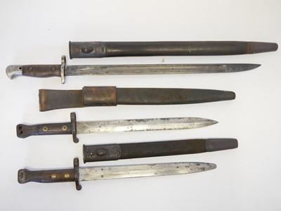 Lot 236 - Three British Lee Enfield rifle bayonets and scabbards