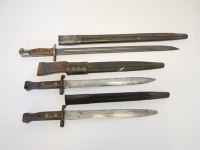 Lot 236 - Three British Lee Enfield rifle bayonets and scabbards