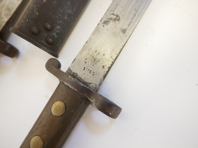 Lot 236 - Three British Lee Enfield rifle bayonets and scabbards