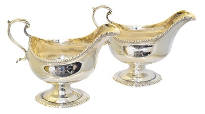 Lot 49 - A pair of George III silver sauce boats