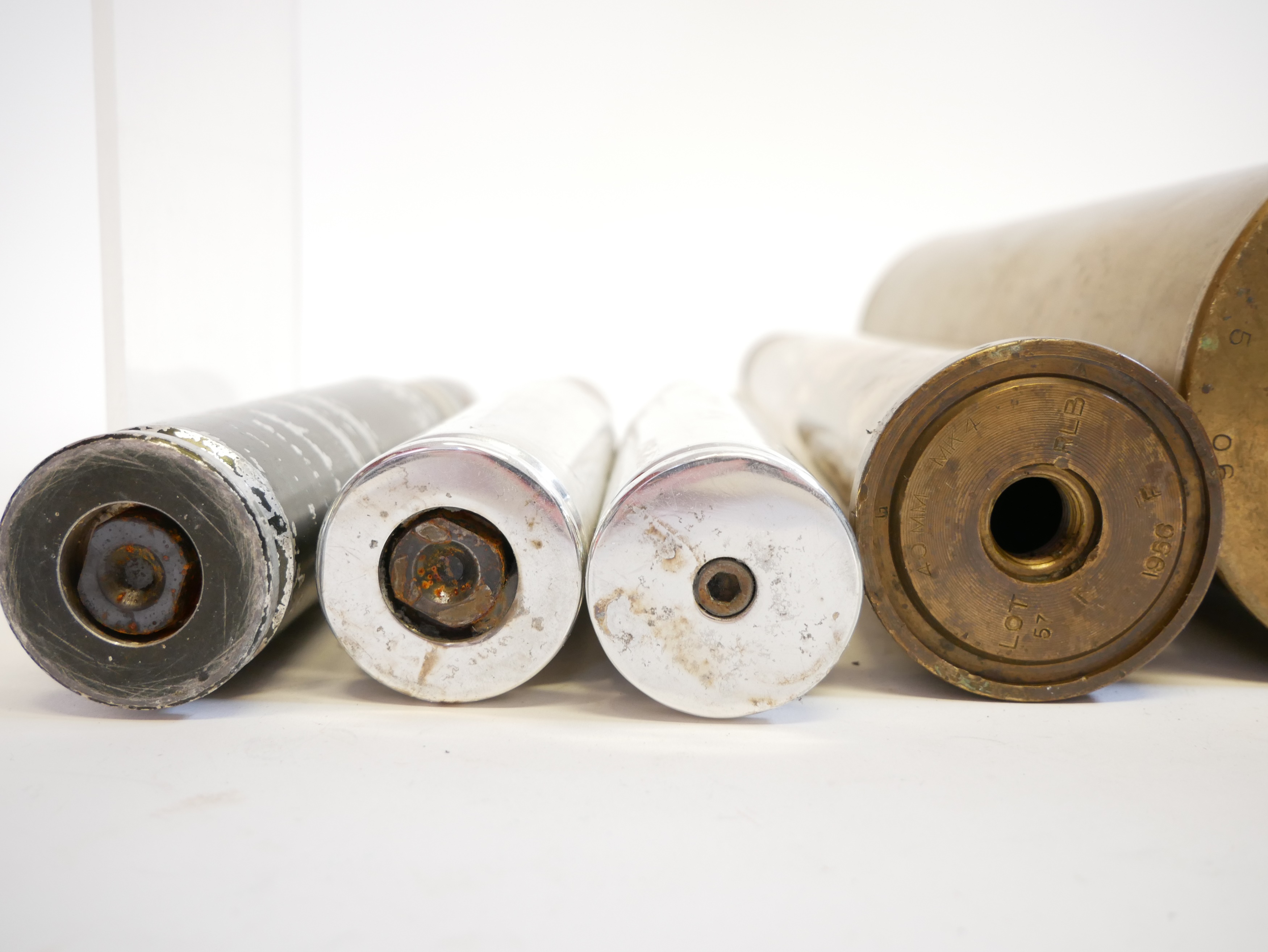 Lot 231 - Four inert artillery rounds and a shell case.