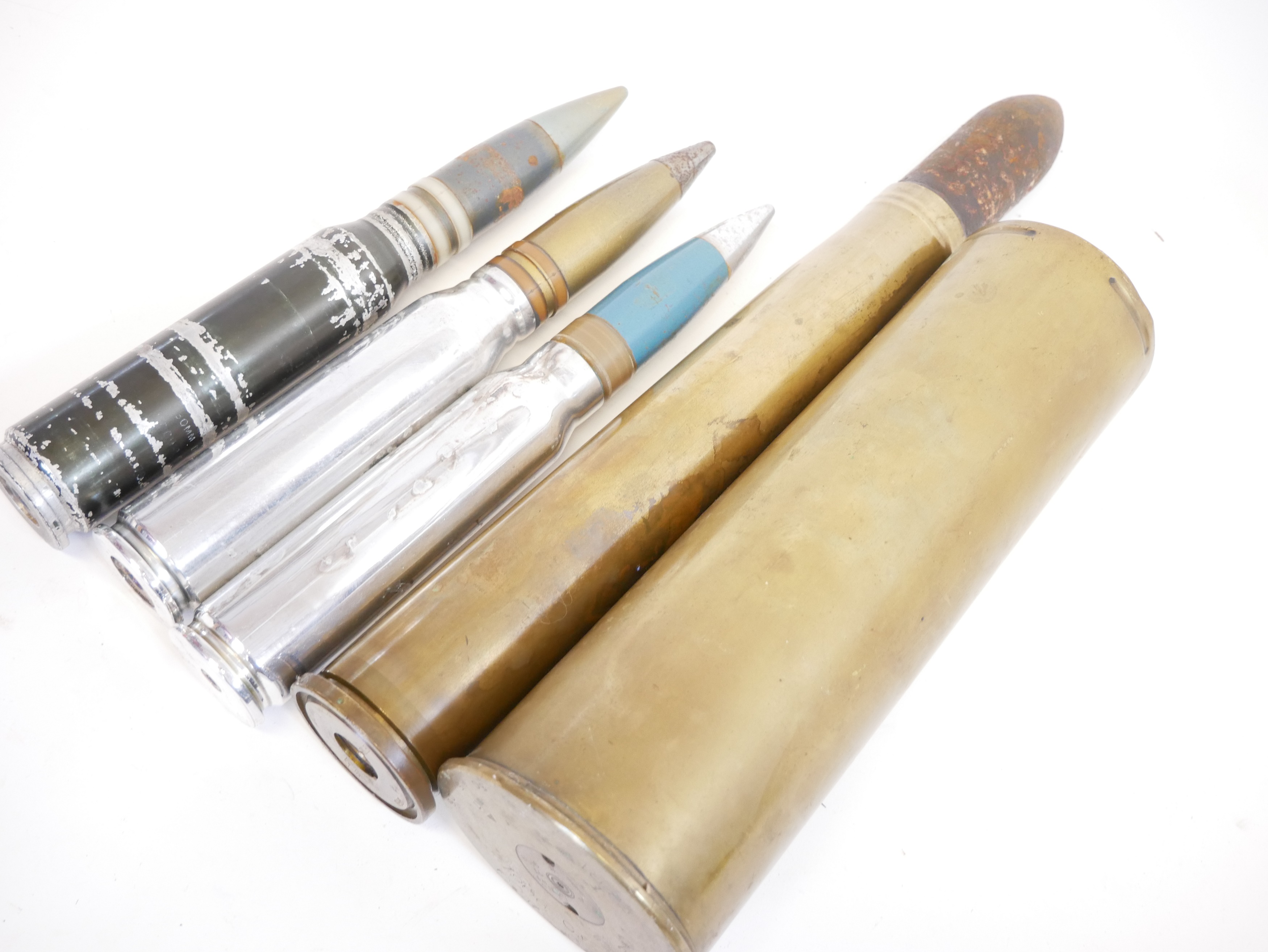 Lot 231 - Four inert artillery rounds and a shell case.