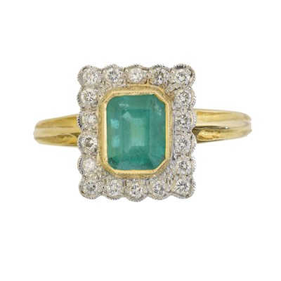 Lot 130 - An 18ct gold emerald and diamond cluster ring