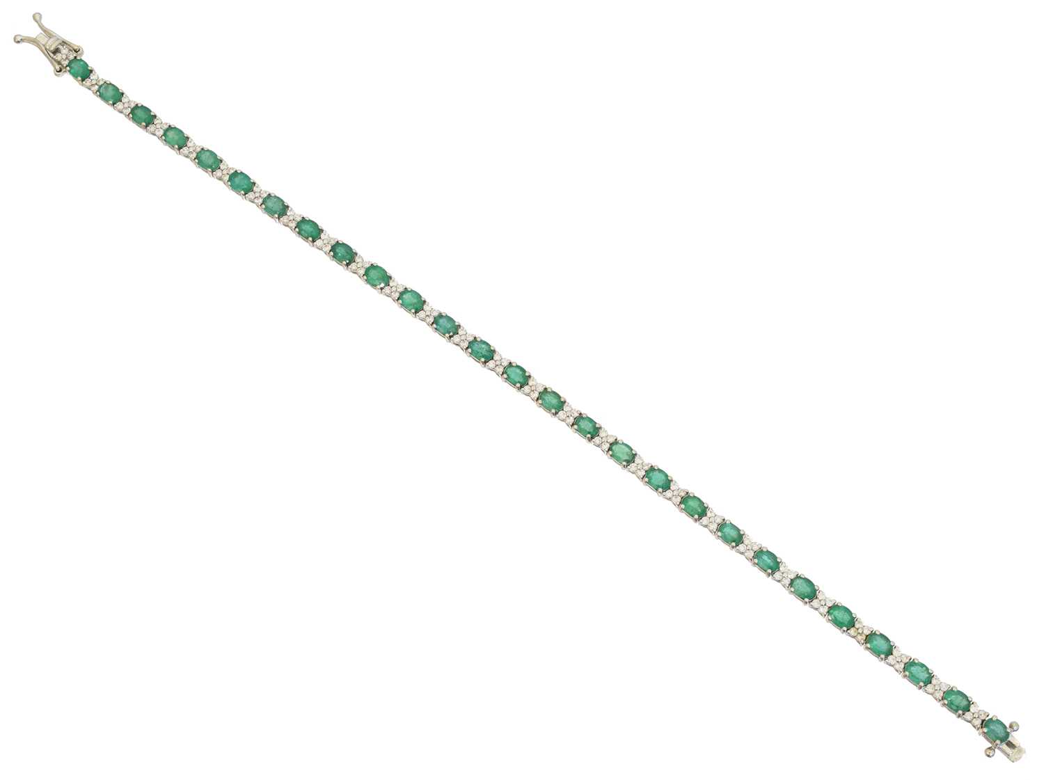Lot 23 - An 18ct gold emerald and diamond bracelet