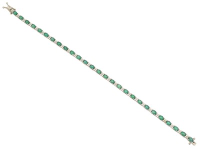 Lot 23 - An 18ct gold emerald and diamond bracelet