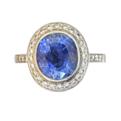 Lot 129 - A platinum sapphire and diamond cluster ring