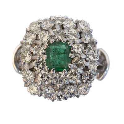 Lot An emerald and diamond cluster ring.