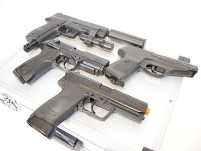 Lot 135 - Four CO2 air pistols with five storage cases,...