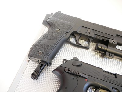 Lot 135 - Four CO2 air pistols with five storage cases,...