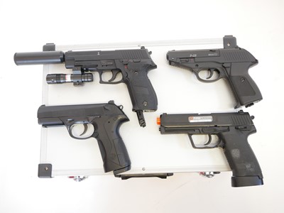 Lot 135 - Four CO2 air pistols with five storage cases,...