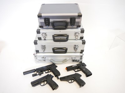 Lot 135 - Four CO2 air pistols with five storage cases,...